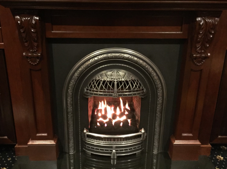 A beautiful and classy fireplace with dark wood surround