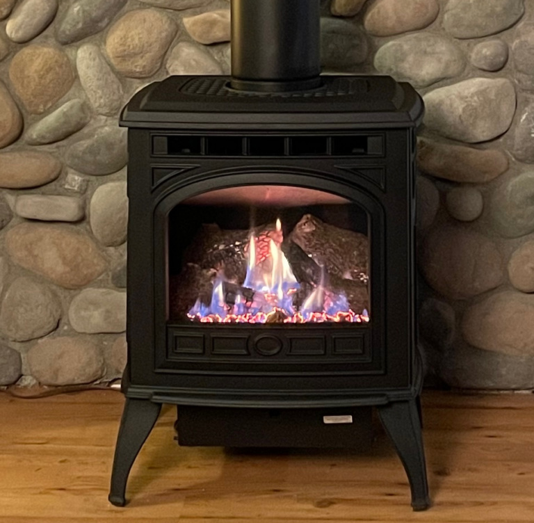 Quadrafire Sapphire free standing stove with river rock background