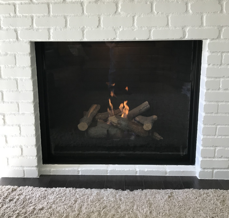An Ortal Traditional fireplace in a classic brick surround.